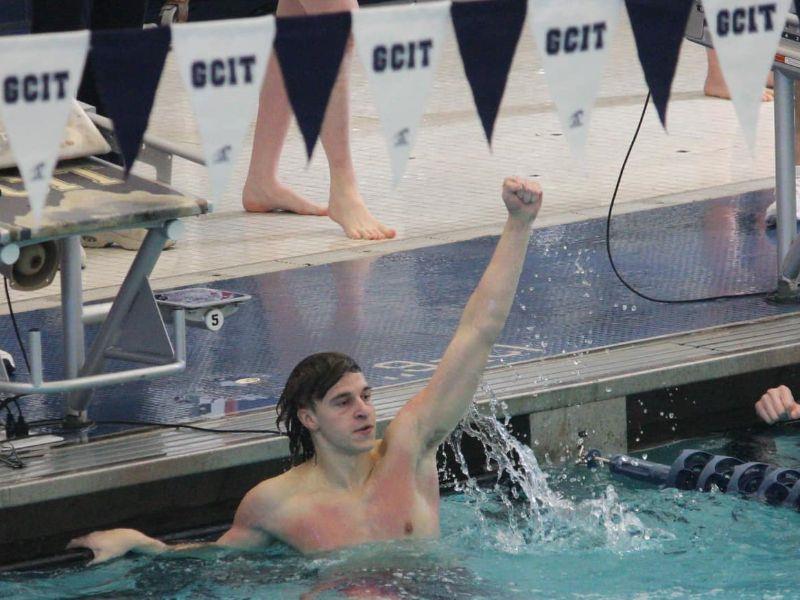 Atlantic CIty High School State Champion Swimmer James Haney raises fist in the sky after victory.